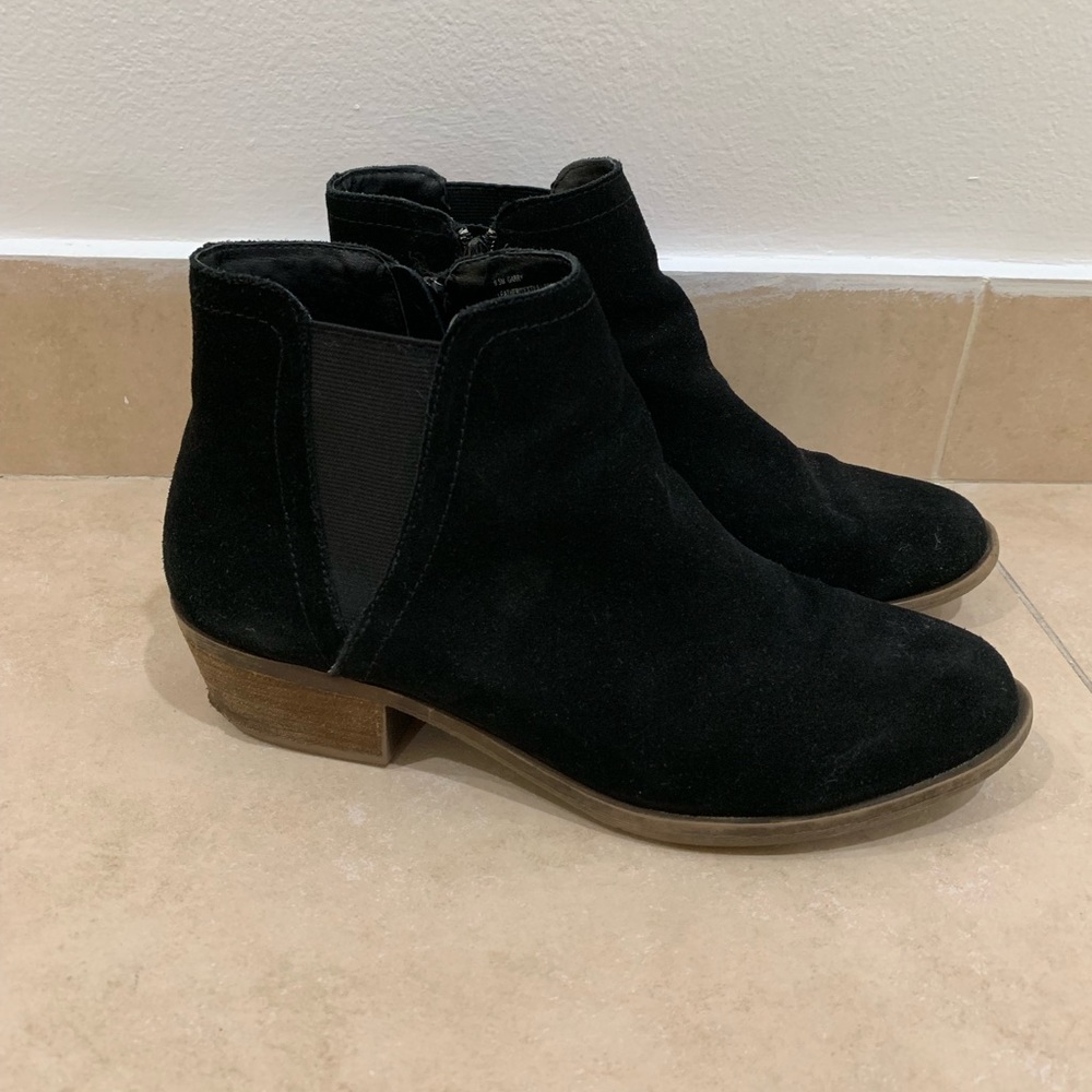 Zip up black leather boots with a slight wedge
